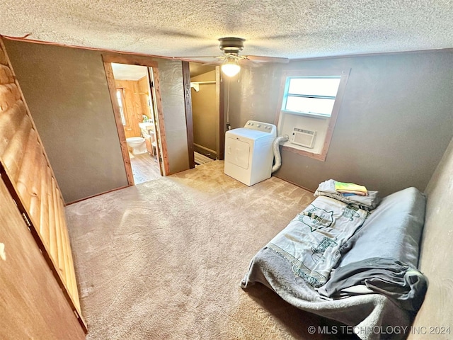 living area featuring a textured ceiling, washer / clothes dryer, light carpet, and ceiling fan