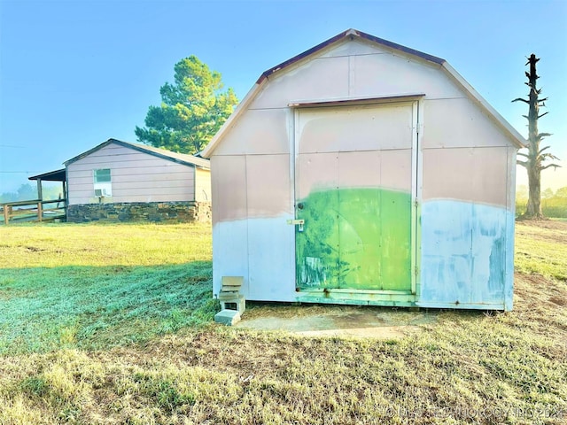 view of outbuilding featuring a lawn