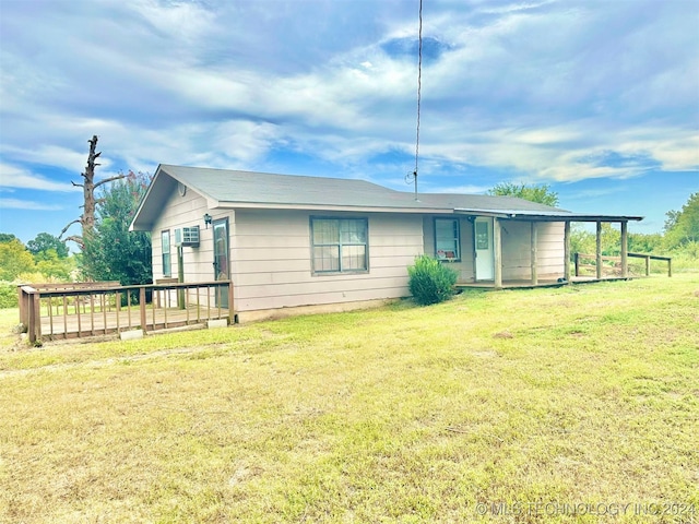 back of property featuring a yard