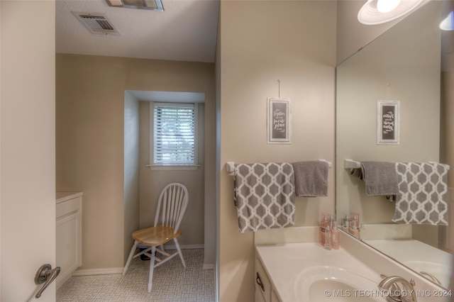 bathroom featuring tile patterned floors, a textured ceiling, and vanity