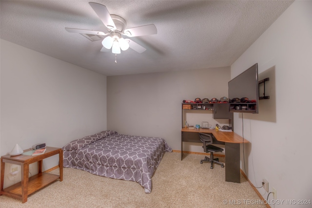 carpeted bedroom with a textured ceiling and ceiling fan