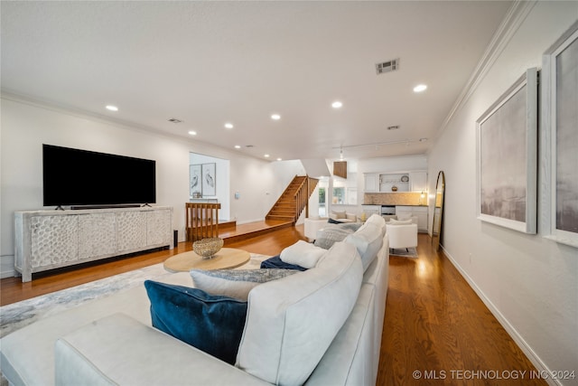 living room featuring ornamental molding and hardwood / wood-style floors