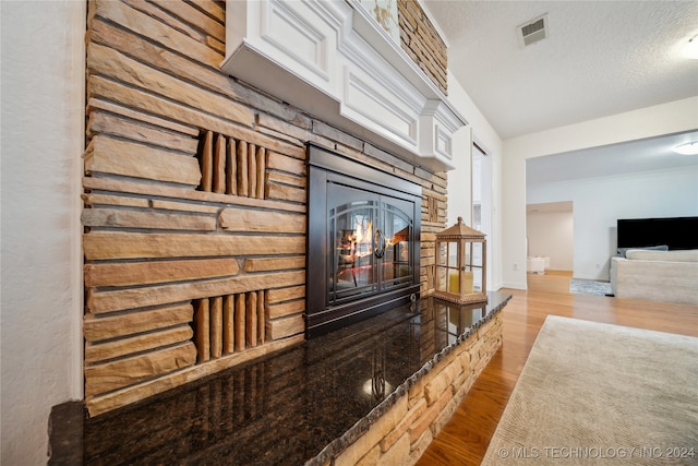 living room with a textured ceiling and light hardwood / wood-style flooring