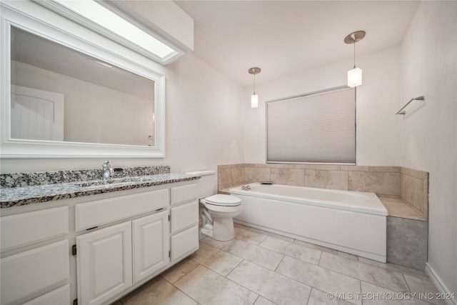 bathroom featuring toilet, vanity, a washtub, and tile patterned flooring