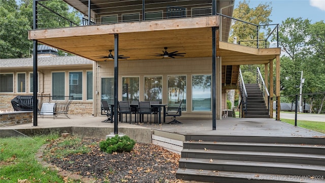 exterior space featuring a balcony, ceiling fan, and a deck