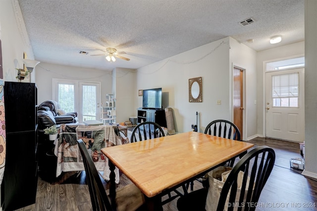 dining space featuring ceiling fan, plenty of natural light, and dark hardwood / wood-style flooring