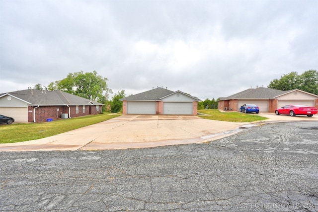 single story home featuring a front yard and a garage