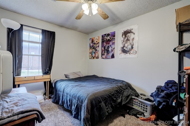 carpeted bedroom with a textured ceiling and ceiling fan