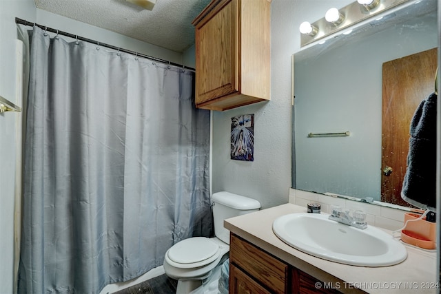 bathroom featuring curtained shower, vanity, a textured ceiling, wood-type flooring, and toilet