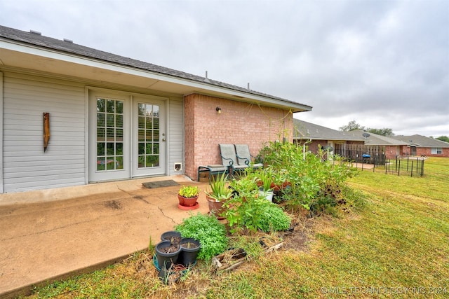 rear view of house featuring a lawn and a patio