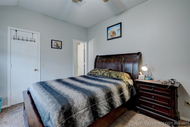 bedroom featuring lofted ceiling and light colored carpet