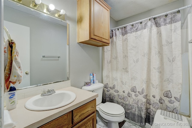 bathroom featuring vanity, toilet, a textured ceiling, and a shower with shower curtain