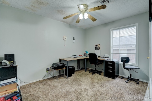 office area with ceiling fan, a textured ceiling, and light carpet