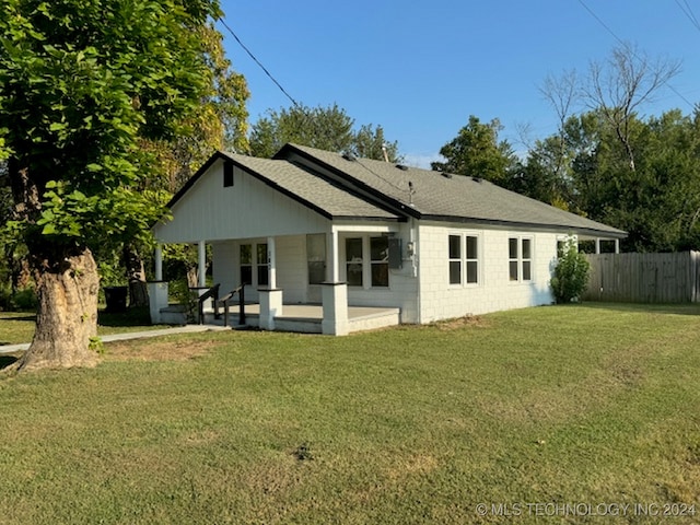 back of property featuring a lawn and a patio area