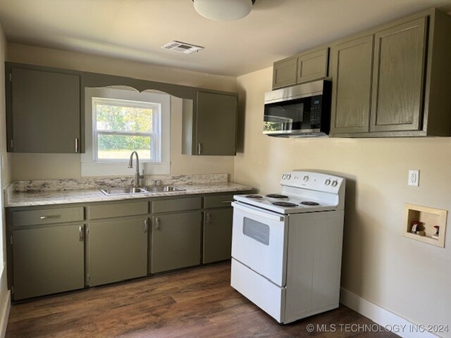 kitchen featuring sink, white electric stove, and dark hardwood / wood-style flooring