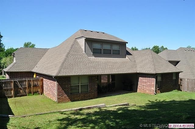 back of house with a yard