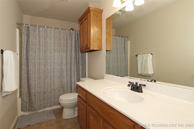 bathroom featuring tile patterned flooring, vanity, toilet, and a shower with shower curtain