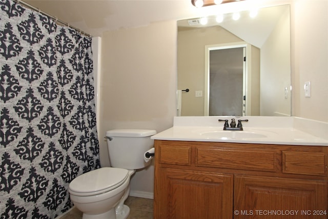 bathroom with tile patterned flooring, vanity, and toilet