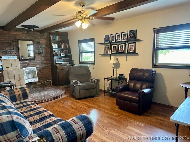 living room featuring ceiling fan, beamed ceiling, and hardwood / wood-style floors