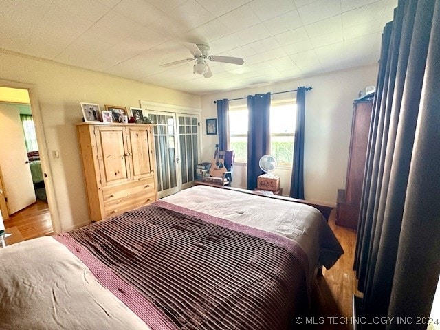 bedroom with hardwood / wood-style floors and ceiling fan