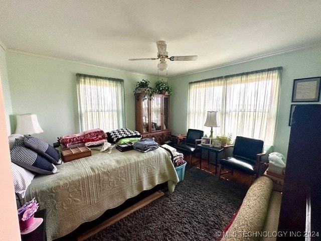 bedroom with ornamental molding and ceiling fan