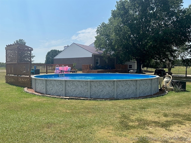 view of swimming pool with a lawn