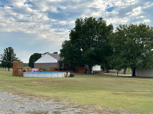 view of yard with a fenced in pool