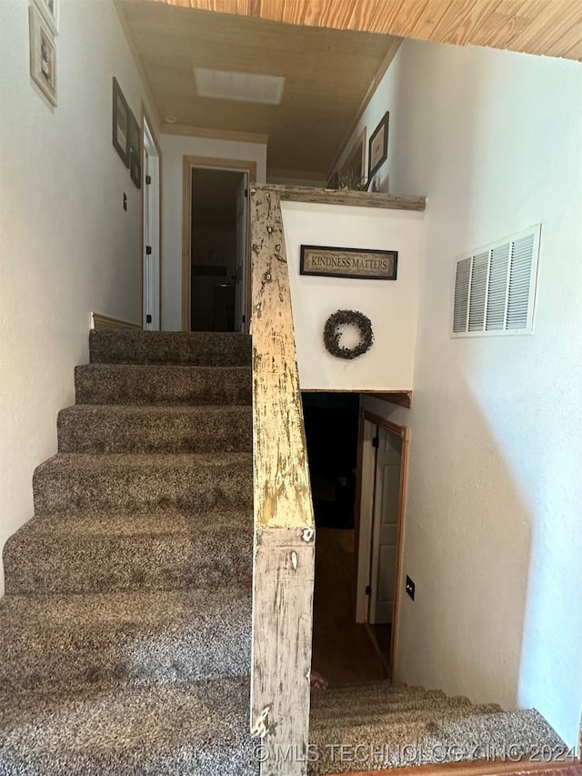 stairway with wooden ceiling