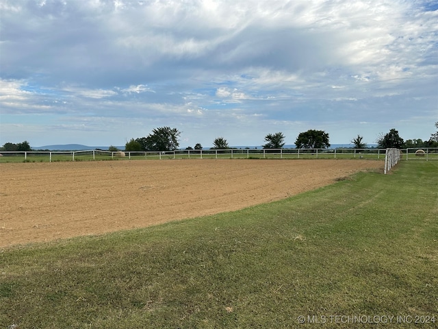 surrounding community featuring a yard and a rural view