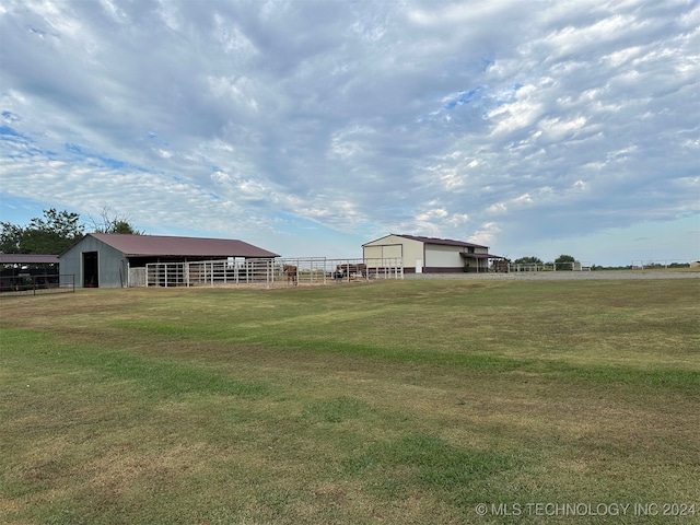 view of yard with an outdoor structure and a rural view