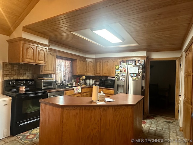 kitchen featuring decorative backsplash, black appliances, and a center island