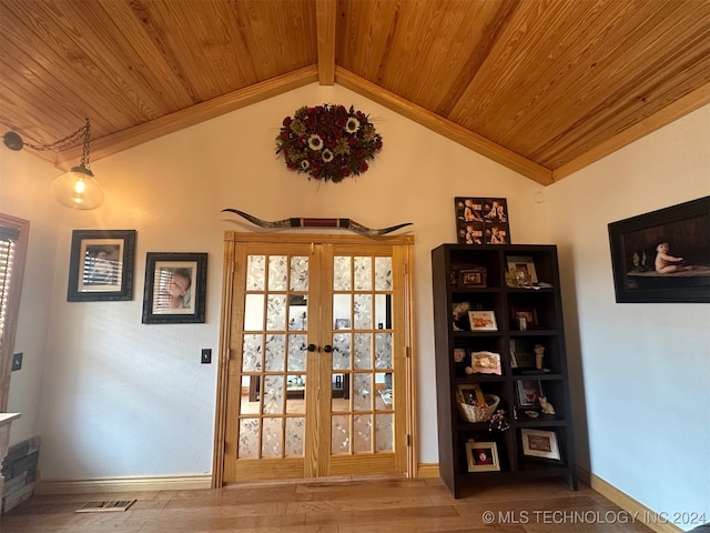 interior space featuring vaulted ceiling with beams, wood ceiling, french doors, and hardwood / wood-style flooring