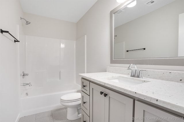 full bathroom featuring tile patterned flooring, shower / bathtub combination, vanity, and toilet