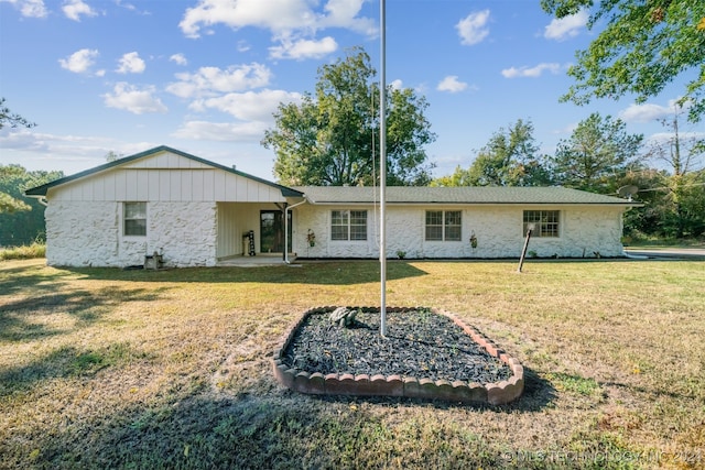 rear view of house with a lawn