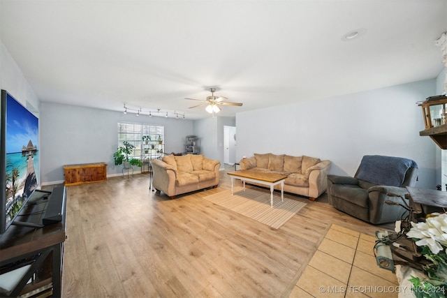 living room with ceiling fan, rail lighting, and light hardwood / wood-style floors