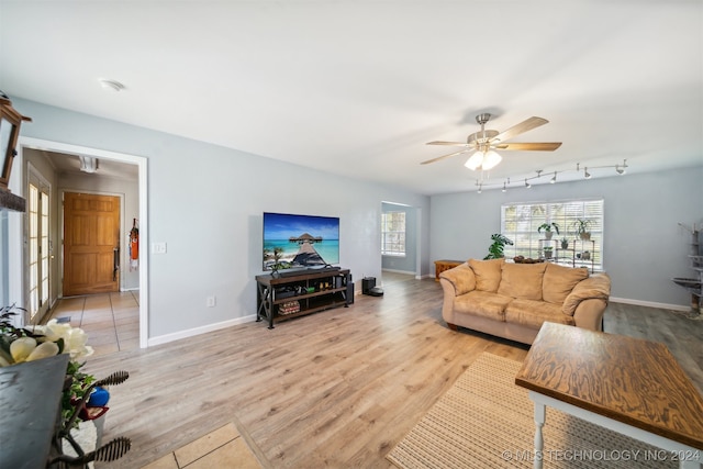 living room featuring ceiling fan and light hardwood / wood-style floors