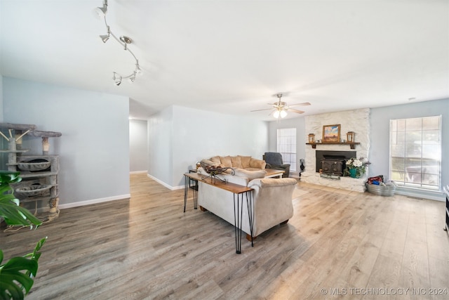 living room with hardwood / wood-style flooring, ceiling fan, and plenty of natural light