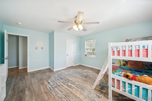 unfurnished bedroom featuring hardwood / wood-style floors and ceiling fan