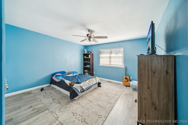 bedroom featuring hardwood / wood-style floors and ceiling fan