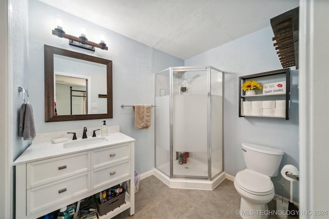 bathroom featuring tile patterned floors, toilet, an enclosed shower, a textured ceiling, and vanity