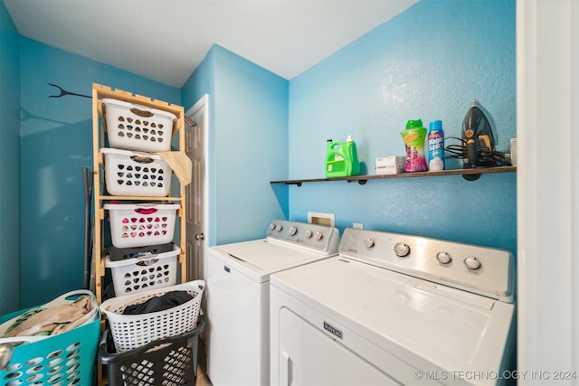 clothes washing area with separate washer and dryer