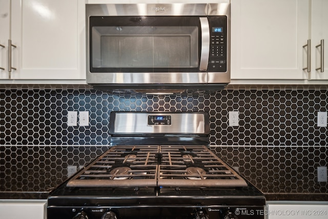 details featuring white cabinets, stainless steel appliances, and tasteful backsplash