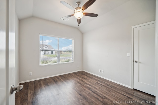 spare room with ceiling fan, lofted ceiling, and dark wood-type flooring