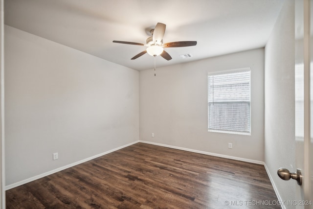 unfurnished room with ceiling fan and dark wood-type flooring