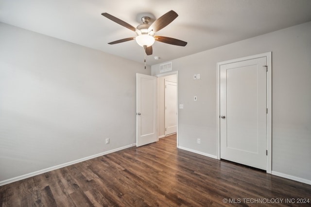 unfurnished bedroom featuring ceiling fan and dark hardwood / wood-style floors