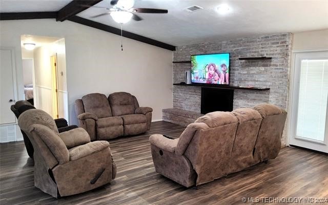 living room featuring a fireplace, lofted ceiling with beams, dark hardwood / wood-style flooring, and ceiling fan