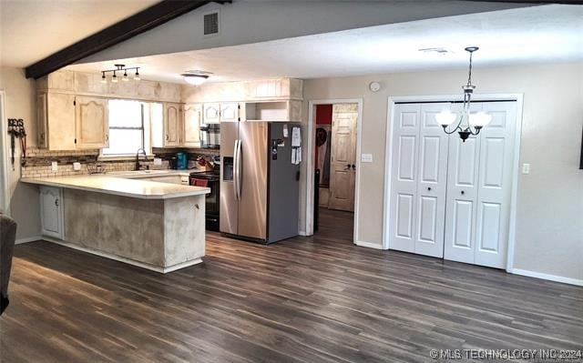 kitchen featuring pendant lighting, kitchen peninsula, appliances with stainless steel finishes, and dark wood-type flooring