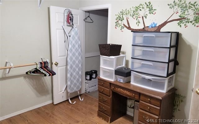 home office with light hardwood / wood-style flooring