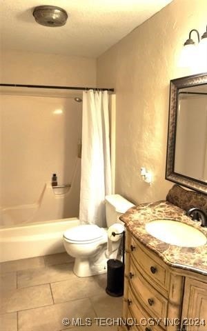 full bathroom featuring vanity, toilet, shower / bathtub combination with curtain, and tile patterned floors