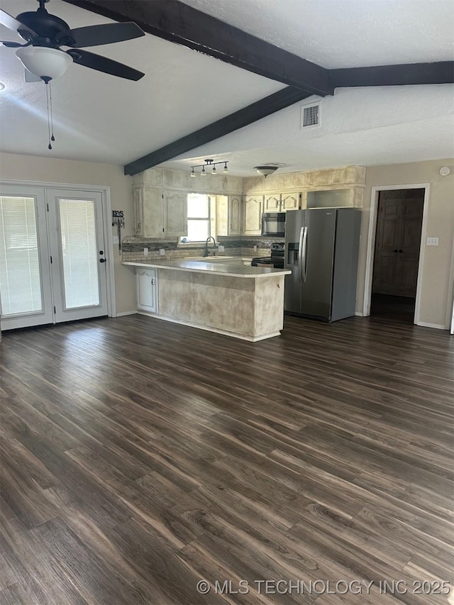 kitchen featuring dark wood-style floors, black appliances, a peninsula, and vaulted ceiling with beams